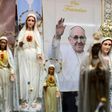 A poster depicts Pope Francis among statues of Our Lady of Fatima in a window shop of souvenirs in Fatima, central Portugal, ahead of his visit