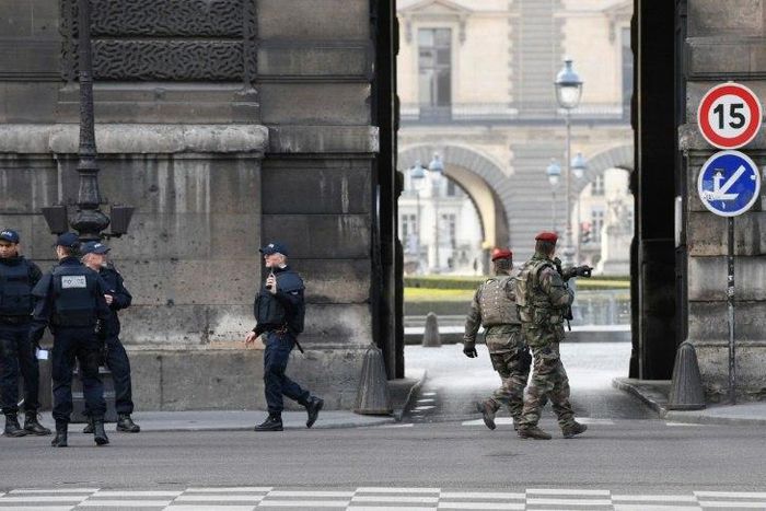 Police and soldiers patrol outside the Louvre on February 3, 2017 in Paris