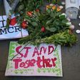 Candles, sings and floral tributes left at a vigil after a suicide bombing at an Ariana Grande concert in Manchester, England