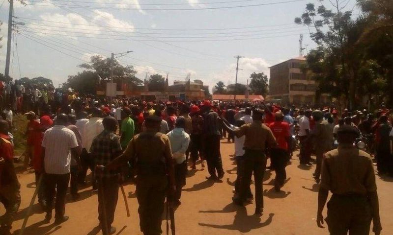 Armed police officers separate supporters of Kenneth Lusaka and Wycliffe Wangamati when they clashed in Bungoma town, June 2, 2017.