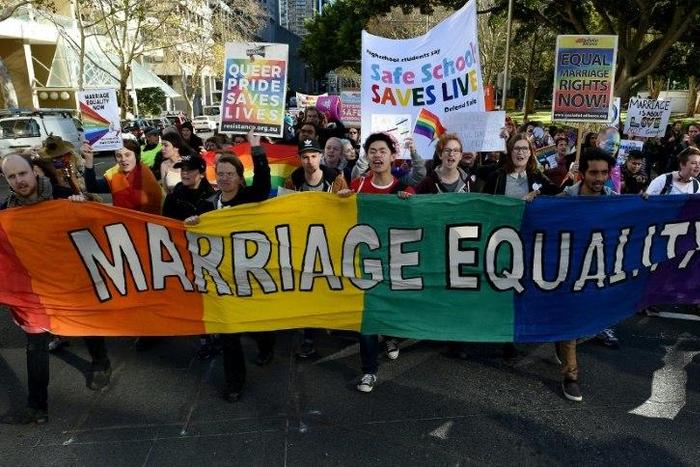 Gay marriage supporters march during a rally in Sydney on June 25, 2016