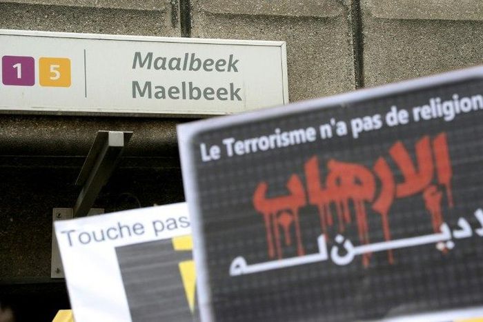 A member of Belgium's Muslim Community holds a sign reading 'Terrorism has no religion' as people take part in a tribute to the victims of March 22 Brussels terror attacks, on April 9, 2016, outside of the Maelbeek/Maalbeek metro station