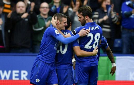 Leicester City's Jamie Vardy (L) is congratulated by teammate Christian Fuchs after scoring a goal during their English Premier League match against Stoke City, at King Power Stadium in Leicester, on April 1, 2017