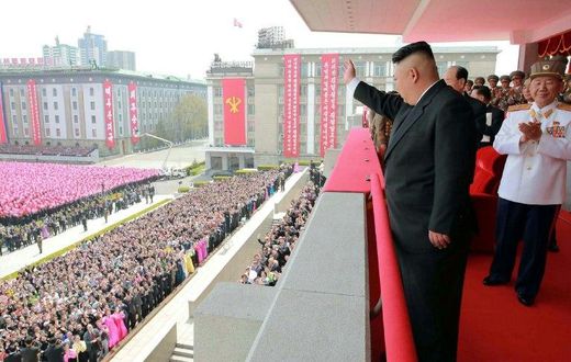 An official Korean Central News Agency image shows leader Kim Jong-Un waving to people after the military parade in Pyongyang on on April 16, 2017