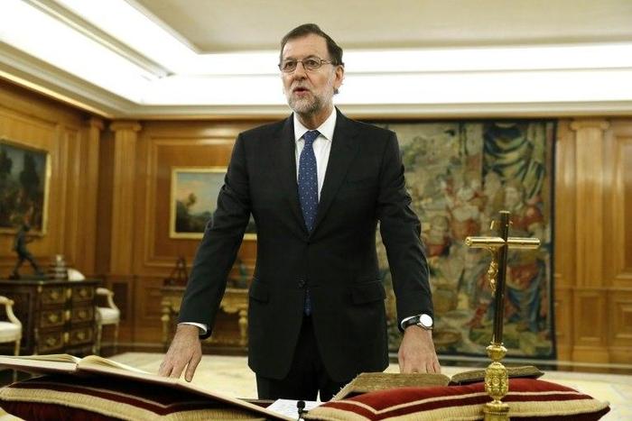Spain's newly re-elected Prime Minister Mariano Rajoy swears an oath during a royal decree ceremony at the Zarzuela Palace in Madrid, on October 31, 2016