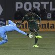Fanendo Adi (R) beats John Alvbage to score as the Portland Timbers beat Minnesota United 5-1 in Oregon