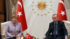 Turkish President Recep Tayyip Erdogan (R) listens on as German Chancellor Angela Merkel speaks during their meeting at the Presidential Palace in Ankara on February 2, 2017