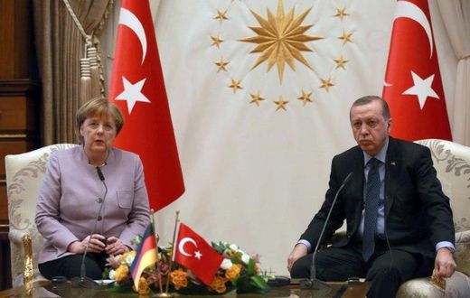 Turkish President Recep Tayyip Erdogan (R) listens on as German Chancellor Angela Merkel speaks during their meeting at the Presidential Palace in Ankara on February 2, 2017