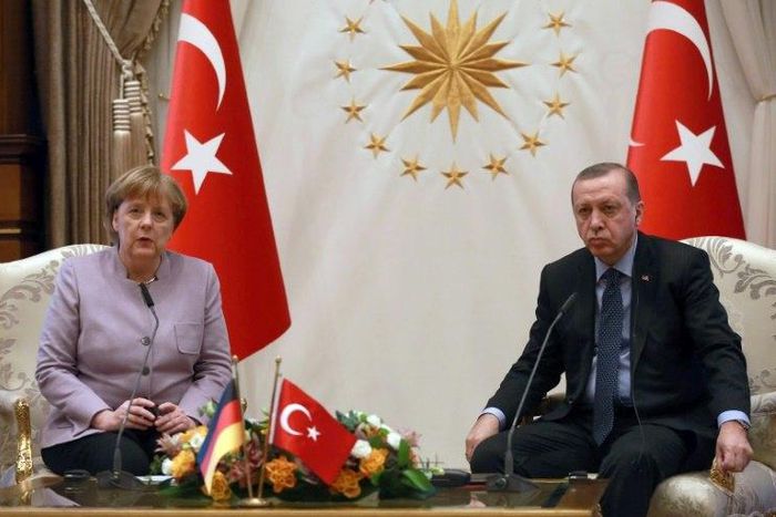 Turkish President Recep Tayyip Erdogan (R) listens on as German Chancellor Angela Merkel speaks during their meeting at the Presidential Palace in Ankara on February 2, 2017