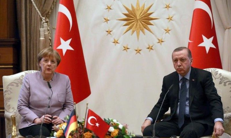 Turkish President Recep Tayyip Erdogan (R) listens on as German Chancellor Angela Merkel speaks during their meeting at the Presidential Palace in Ankara on February 2, 2017