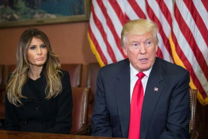 Melania Trump (L) listens to her husband US President-elect Donald Trump speak to the press at the US Capitol on November 10, 2016