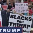 File photo shows then Republican presidential nominee Donald Trump kissing a "Women for Trump" placard during a rally in Florida