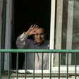 Former Egyptian president Hosni Mubarak waves to supporters from his room at the Maadi military hospital in Cairo on October 6, 2016