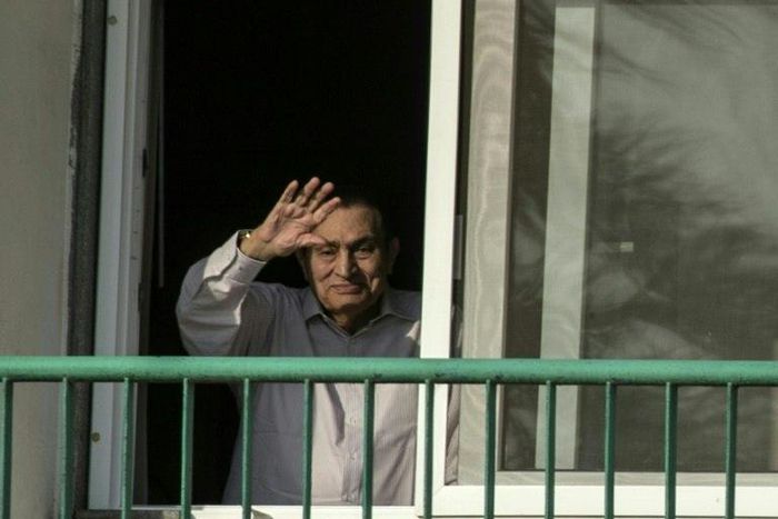 Former Egyptian president Hosni Mubarak waves to supporters from his room at the Maadi military hospital in Cairo on October 6, 2016