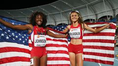 Sydney McLaughlin and Brandee Johnson of the USA celebrate with flags after the Girls 400 Meters Hurdles Final at a past Youth Championships.