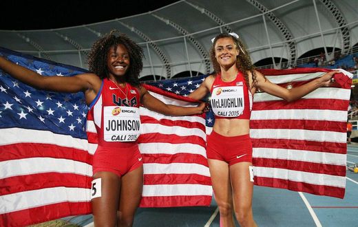 Sydney McLaughlin and Brandee Johnson of the USA celebrate with flags after the Girls 400 Meters Hurdles Final at a past Youth Championships.