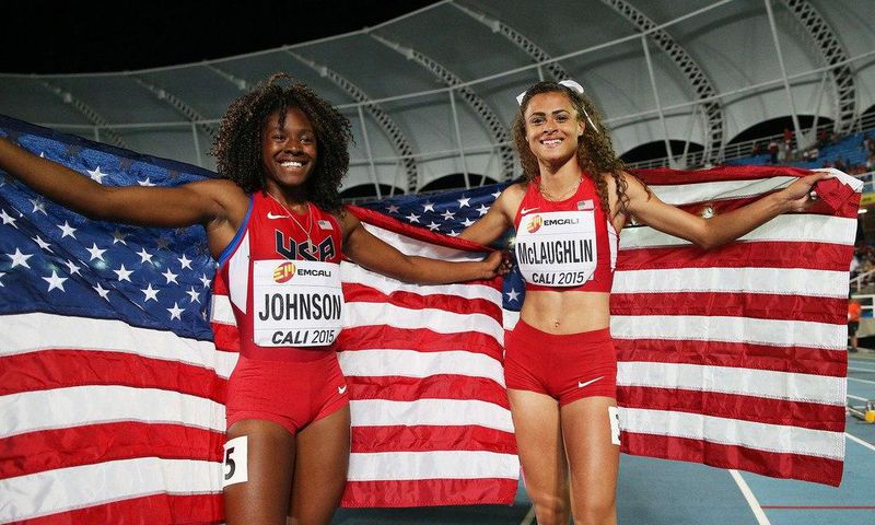 Sydney McLaughlin and Brandee Johnson of the USA celebrate with flags after the Girls 400 Meters Hurdles Final at a past Youth Championships.