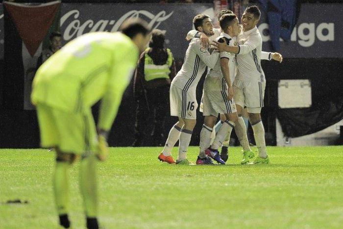Real Madrid's players celebrate after the team's third goal against Osasuna at El Sadar stadium in Pamplona on February 11, 2017