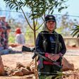 A member of the FARC leftist guerrilla stands guard at the entrance to the area where the rebels are gathering in the municipality of San Jose de Oriente, Cesar department, northern Colombia on February 28, 2017