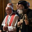 Pope Francis (L) walks alongside Coptic Pope Tawadros II (R) during a visit to Cairo on April 28, 2017