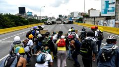 Opposition activists and riot police face off during a protest against President Nicolas Maduro, in Caracas, on May 8, 2017