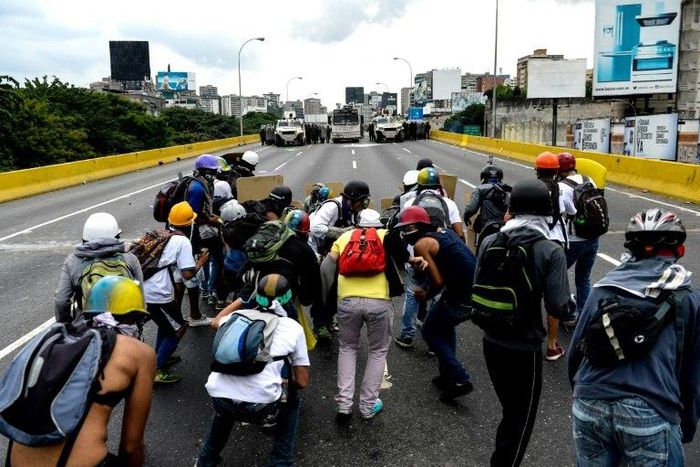 Opposition activists and riot police face off during a protest against President Nicolas Maduro, in Caracas, on May 8, 2017