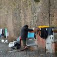 A homeless women does her laundry where she lives near the Vatican, which announced the opening of a free launderette for the poor and homeless