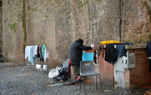 A homeless women does her laundry where she lives near the Vatican, which announced the opening of a free launderette for the poor and homeless