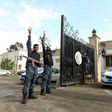 Libyan security forces flash victory signs outside the Guest Palace, a complex of luxury villas in central Tripoli on March 15, 2017