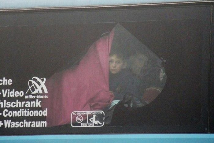 A Syrian boy onboard a bus from government-held Fuaa and Kafraya arrives in rebel-held Rashidin as part of an evacuation deal on April 14, 2017