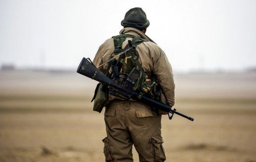 A member of the Syrian Democratic Forces, made up of US-backed Kurdish and Arab fighters, stands guard near the village of Bir Fawaz, in February 2017