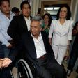 The Ecuadorean presidential candidate of the Alianza PAIS party, Lenin Moreno, accompanied by his wife Rocio Gonzalez (in white), arrives at a polling station in Quito on February 19, 2017 to vote during general election