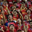 Fans of China's Guangzhou Evergrande chant slogans at supporters of Hong Kong's Eastern during an AFC Champions League football match between the two sides in Hong Kong
