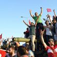 Turkish pro-regime activists celebrate after seizing a tank in Istanbul, during the failed July 15 coup in which 300 people were killed