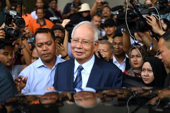 Former PR guru Paul Stadlen was known for staunchly defending Najib Razak (C) even as corruption allegations against him multiplied