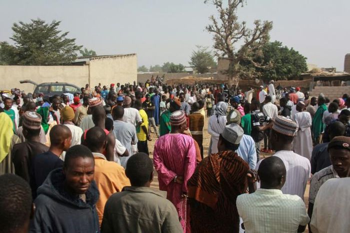 People walk in the streets of the Sajeri village on the outskirts of the Borno state capital, Maiduguri, on January 8, 2019 as they gather for the funerals of the victims of an attack the day before