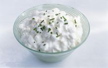 Bowl of cottage cheese with chives, close-up
