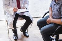 Male doctor and testicular cancer patient are discussing about testicular cancer test report. Testicular cancer and prostate cancer concept.