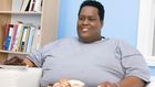 Fat man holding snacks(Ebony Magazine)