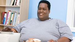 Fat man holding snacks(Ebony Magazine)