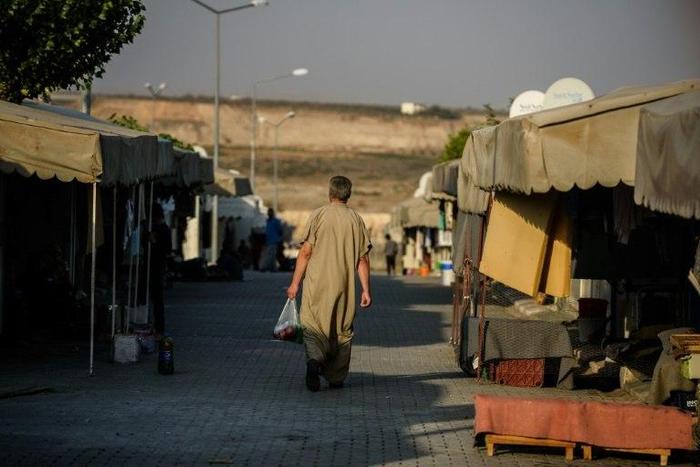 A Syrian man walks at a refugee camp in the Kilis district of Gaziantep, southeastern Turkey, on October 23, 2016