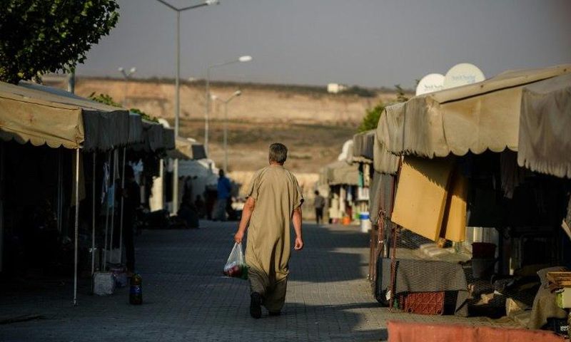A Syrian man walks at a refugee camp in the Kilis district of Gaziantep, southeastern Turkey, on October 23, 2016