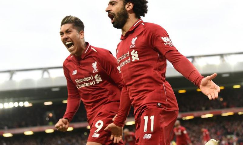 Liverpool's Mohamed Salah (right) and Roberto Firmino (left) celebrate a huge win for their title ambitions