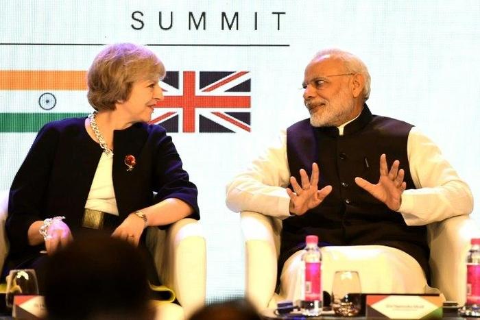 British Prime Minister Theresa May speaks with India's counterpart Narendra Modi as they attend The India-UK Tech Summit in New Delhi, on November 7, 2016