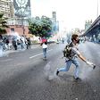 Venezuelan opposition activists chanting "No more dictatorship!" hurled stones at National Guard riot police who blocked them from marching on central Caracas
