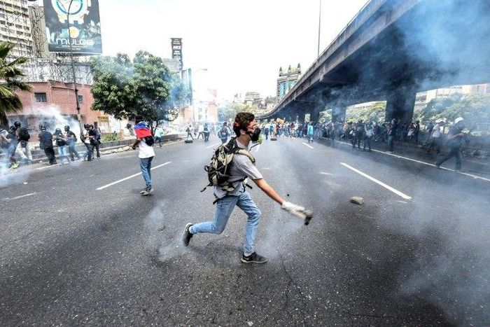 Venezuelan opposition activists chanting "No more dictatorship!" hurled stones at National Guard riot police who blocked them from marching on central Caracas