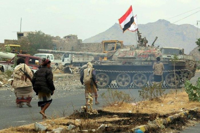 Yemeni fighters loyal to Yemen's exiled President Abedrabbo Mansour Hadi, drive a tank during clashes with Shiite Huthi rebels in the country's third-city of Taez on December 19, 2016