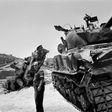 An Israeli soldier checks a destroyed tank on the road between Bethleem and Jerusalem in June 1967 during the Six-Day War