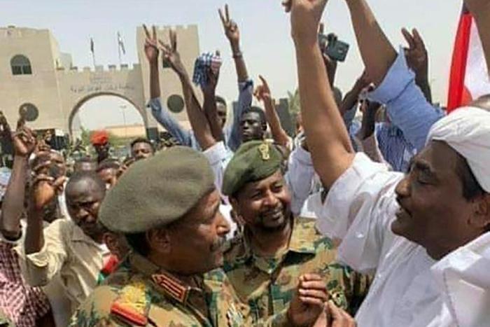 A handout picture released by the Twitter account of the official Sudan News Agency shows General Abdel Fattah al-Burhan speaking with demonstrators outside the army headquarters