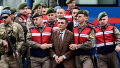 Security forces escorting suspects ahead of a hearing in Mugla where 47 people went on trial over alleged coup links earlier this month